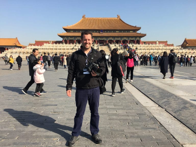 Evan Parker standing in front of a historic landmark during travel to China